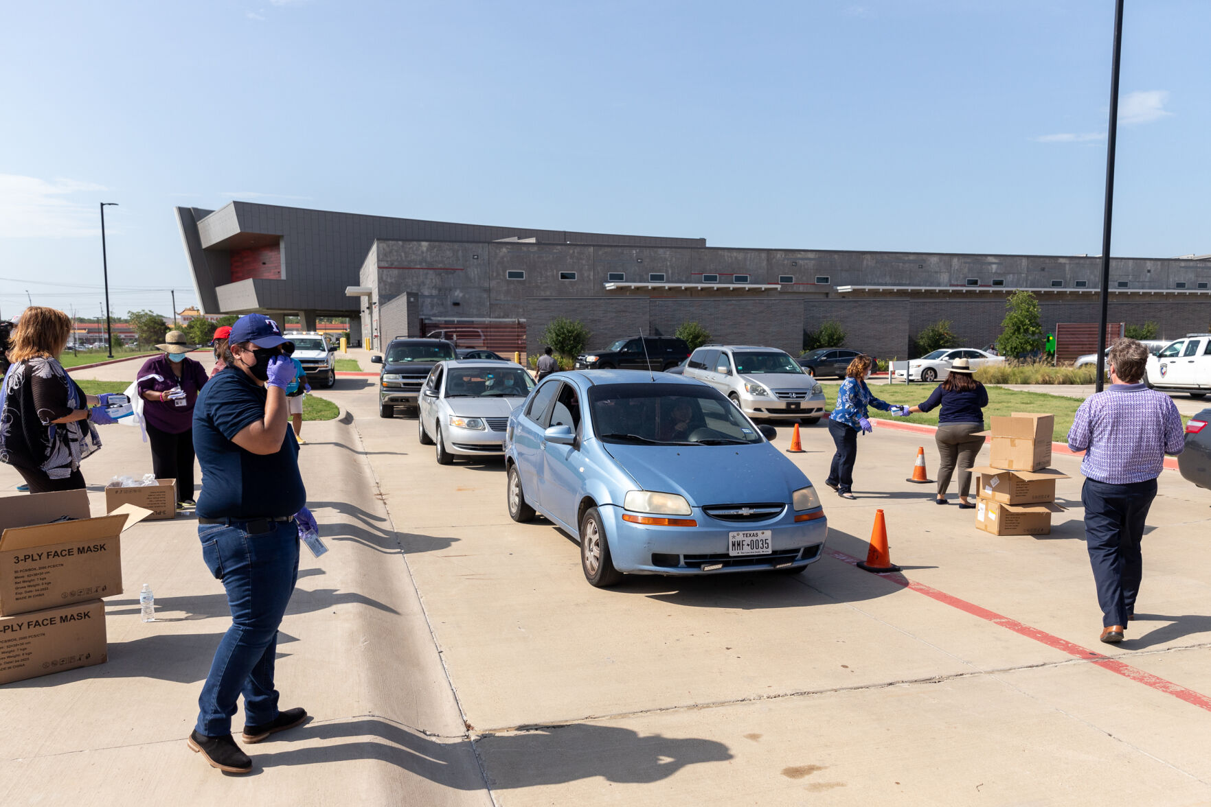Photos: Cars line up for over three miles at Arlington face mask distribution